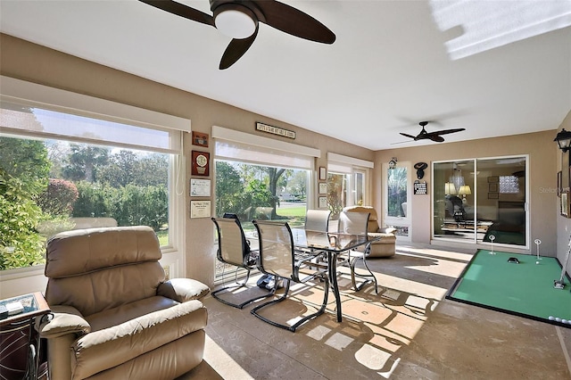 sunroom / solarium with a ceiling fan