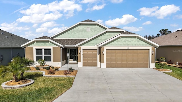 view of front facade with a garage, concrete driveway, roof with shingles, a front lawn, and stucco siding