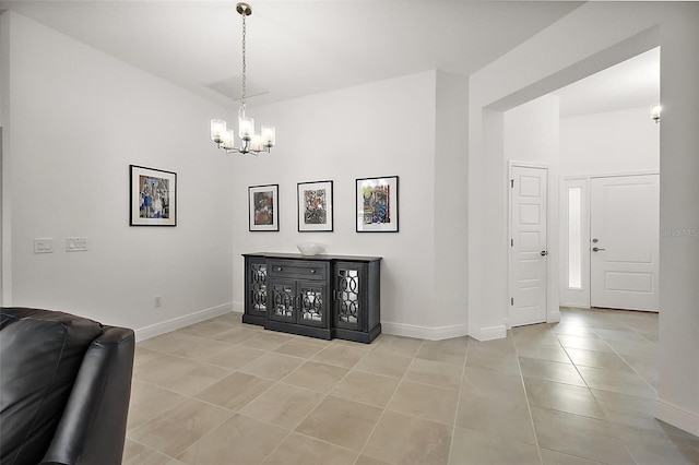 interior space with a notable chandelier, baseboards, and light tile patterned floors