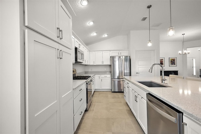 kitchen with decorative light fixtures, visible vents, appliances with stainless steel finishes, white cabinets, and a sink