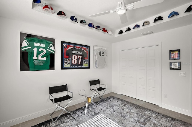 living area with visible vents, baseboards, a ceiling fan, and tile patterned floors