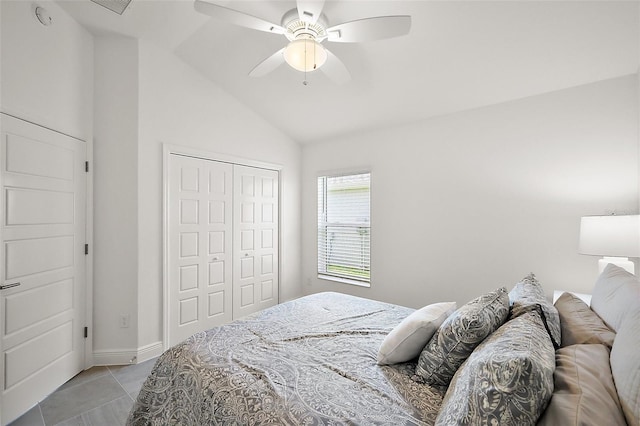 bedroom featuring light tile patterned floors, baseboards, ceiling fan, vaulted ceiling, and a closet