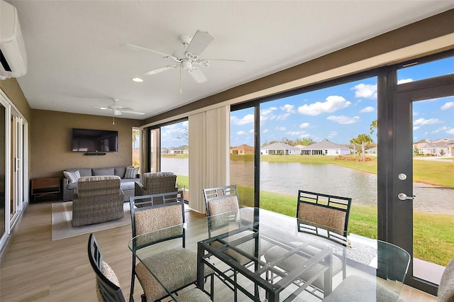 sunroom with a wall mounted air conditioner