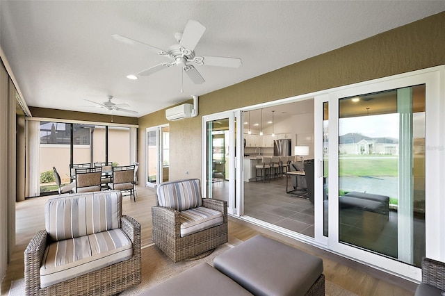 sunroom / solarium with a wealth of natural light, ceiling fan, and a wall mounted AC