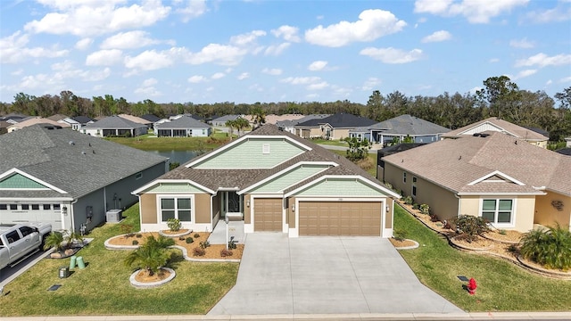 single story home featuring a garage, driveway, a residential view, and a front yard