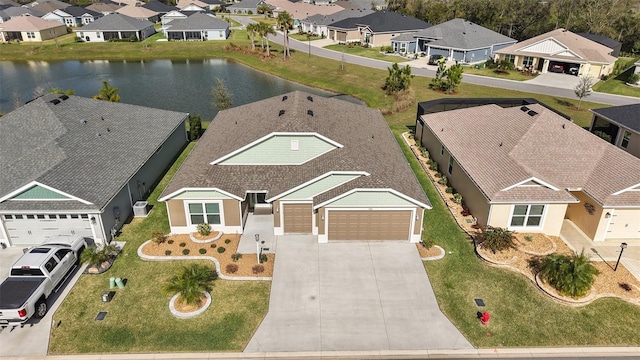 birds eye view of property with a residential view and a water view