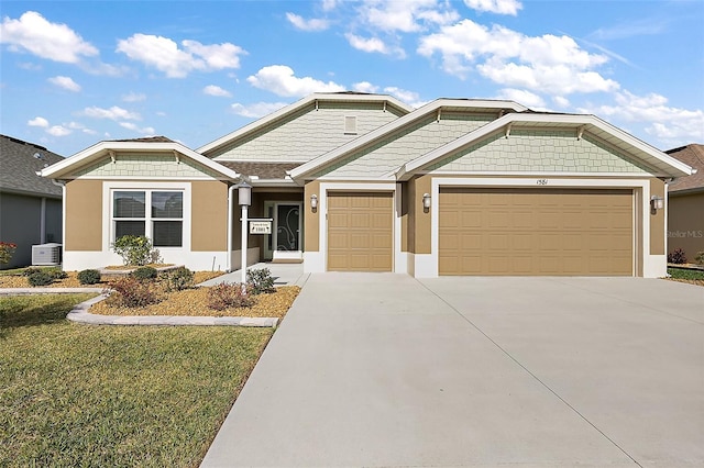 view of front of house with driveway, an attached garage, and stucco siding