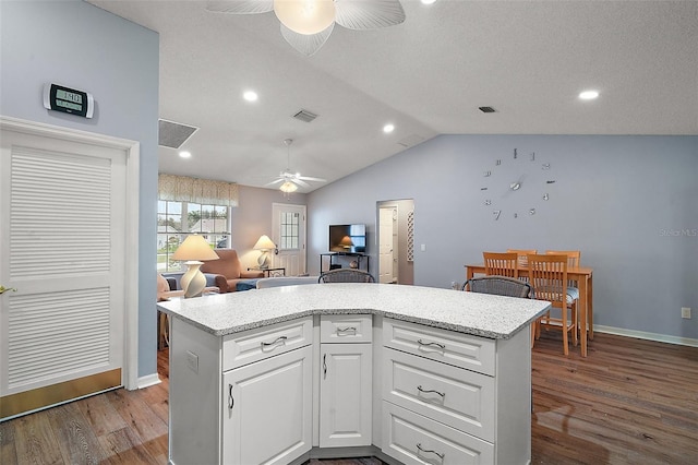 kitchen with visible vents, a ceiling fan, lofted ceiling, open floor plan, and dark wood-style flooring