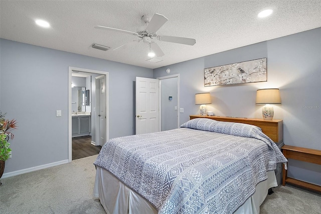 carpeted bedroom with baseboards, visible vents, ceiling fan, and a textured ceiling