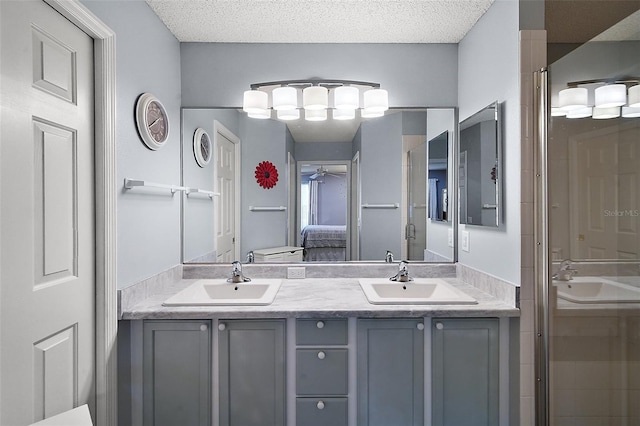 full bath featuring double vanity, ensuite bath, and a sink