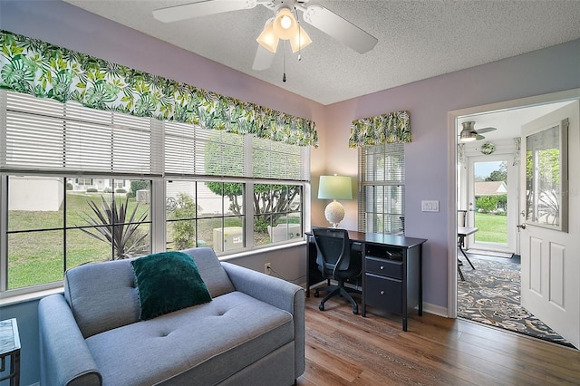 office with a ceiling fan, a textured ceiling, and wood finished floors