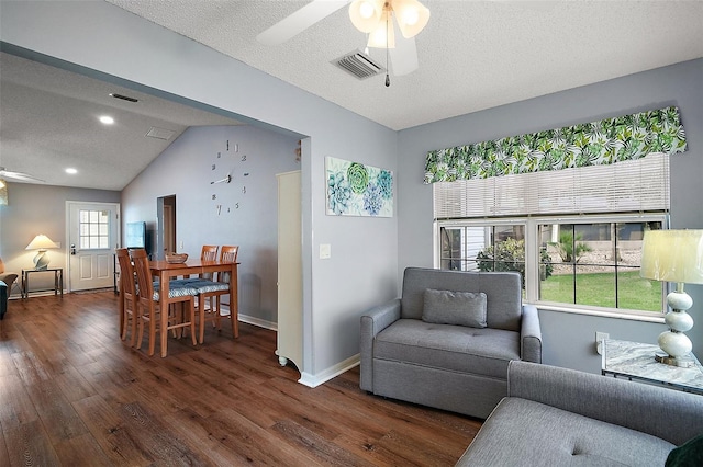 living area featuring visible vents, a ceiling fan, a textured ceiling, wood finished floors, and baseboards