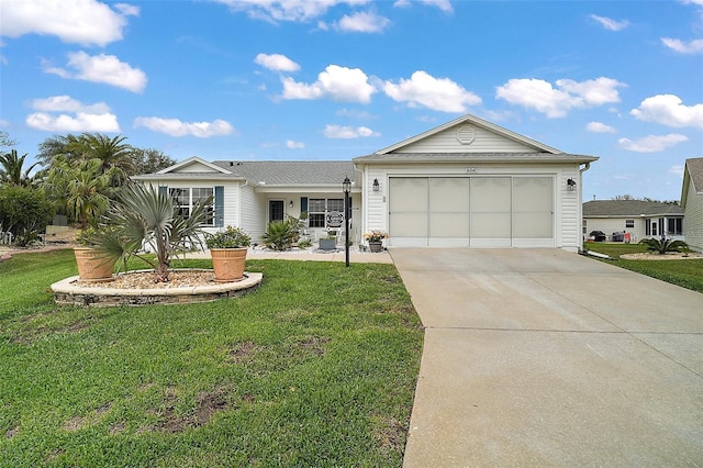 ranch-style house featuring a garage, concrete driveway, and a front yard