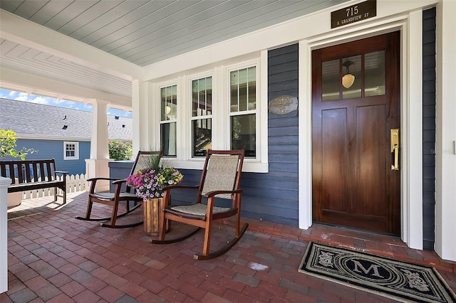 view of exterior entry with covered porch