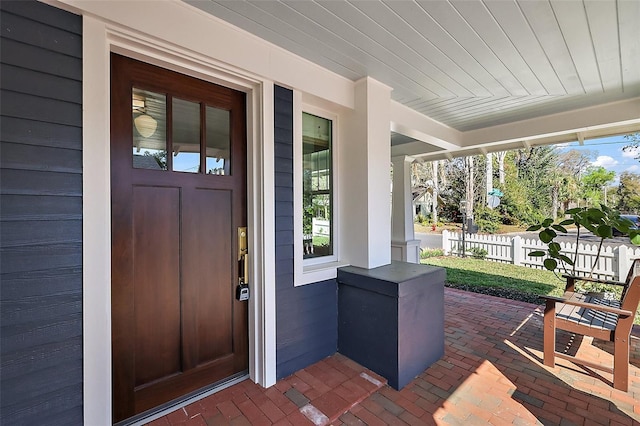 view of exterior entry with a porch