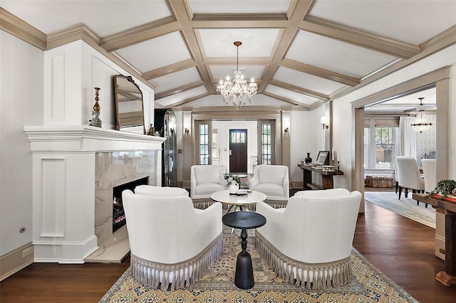 living room with dark wood finished floors, a fireplace, lofted ceiling with beams, a chandelier, and coffered ceiling