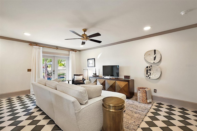 living area with dark floors, french doors, ornamental molding, ceiling fan, and baseboards