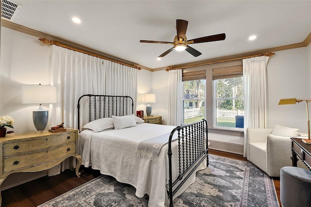 bedroom with dark wood-style floors, visible vents, and ornamental molding