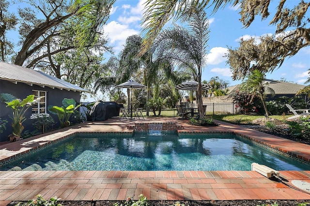 view of pool with a fenced in pool, a patio area, and fence