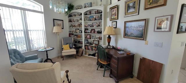 home office featuring a chandelier and light carpet