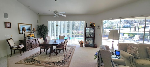 dining space featuring light colored carpet, lofted ceiling, visible vents, and a ceiling fan