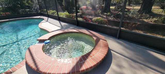 view of swimming pool with a lanai and a pool with connected hot tub