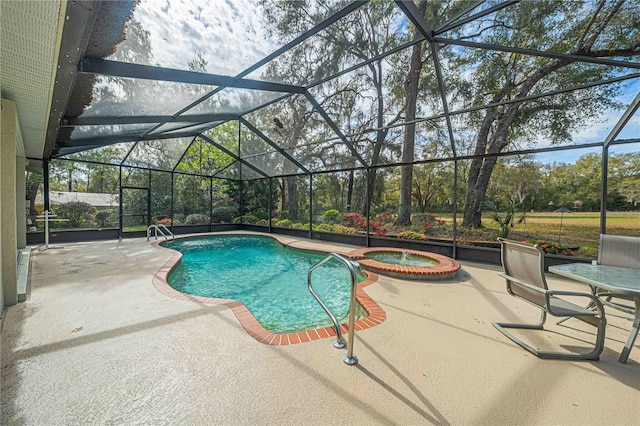 view of pool featuring a patio area, a pool with connected hot tub, and glass enclosure