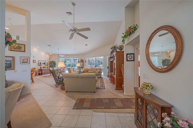 living room with light tile patterned floors, high vaulted ceiling, and light colored carpet
