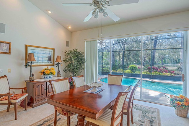 carpeted dining space featuring a ceiling fan, a sunroom, a healthy amount of sunlight, and visible vents