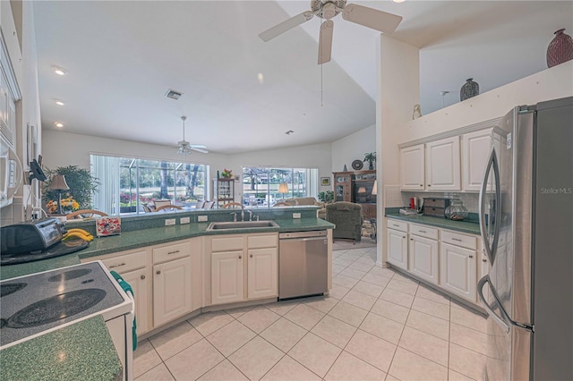 kitchen featuring light tile patterned flooring, stainless steel appliances, a sink, visible vents, and open floor plan
