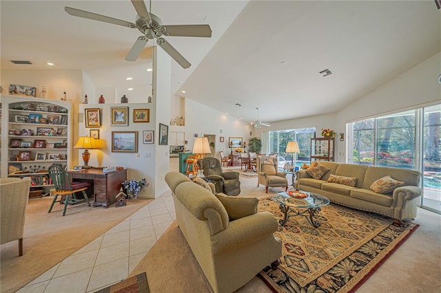 living area with light tile patterned floors, visible vents, a ceiling fan, light carpet, and high vaulted ceiling