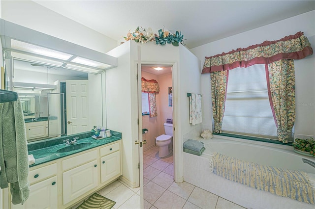 bathroom with toilet, a garden tub, tile patterned flooring, and vanity