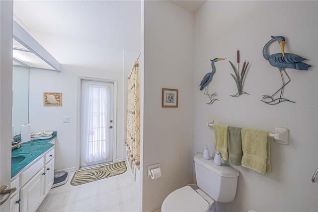 full bathroom featuring vanity, toilet, and tile patterned floors