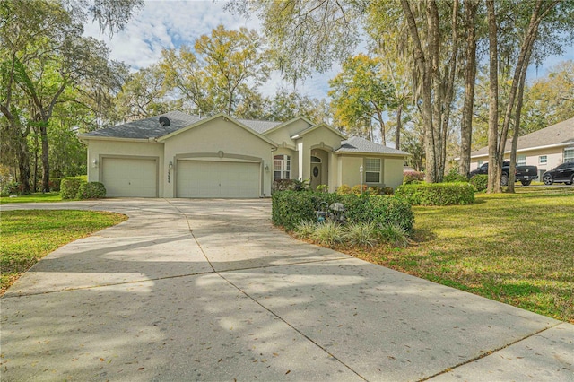 ranch-style house with stucco siding, a shingled roof, an attached garage, a front yard, and driveway
