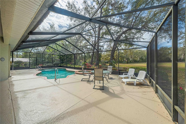 view of swimming pool with a patio area, a pool with connected hot tub, and glass enclosure