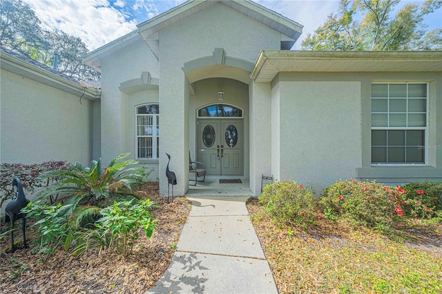 doorway to property with stucco siding
