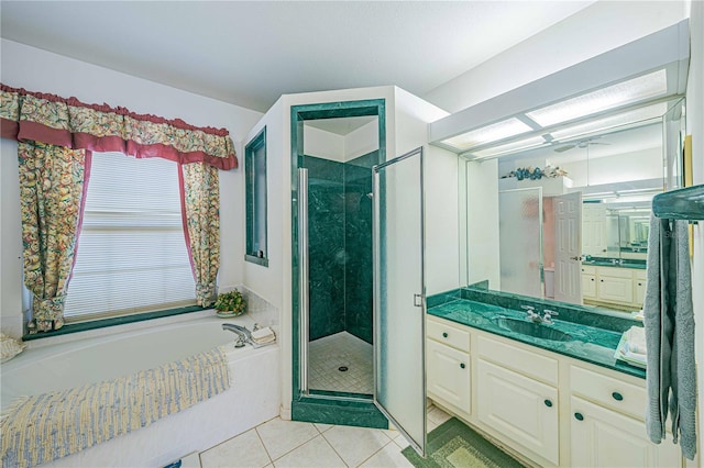 bathroom featuring tile patterned flooring, a shower stall, vanity, and a bath