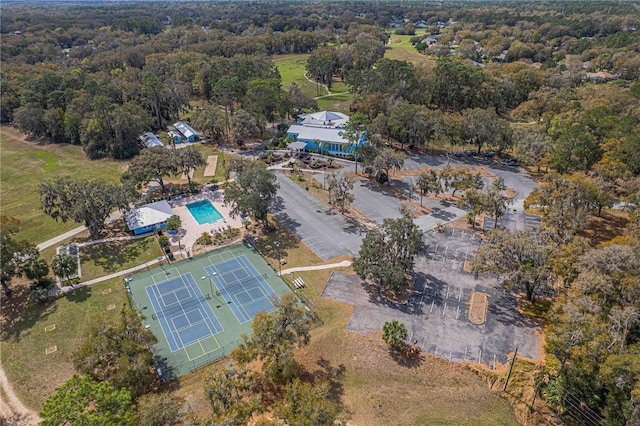 birds eye view of property featuring a view of trees