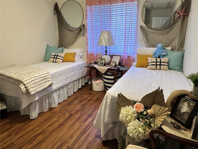 bedroom with dark wood-style flooring