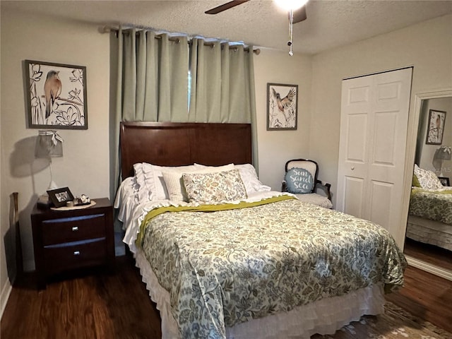 bedroom featuring dark wood-style floors, a closet, a textured ceiling, and a ceiling fan