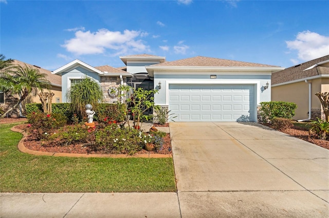 view of front of property featuring a garage, driveway, a front lawn, and stucco siding