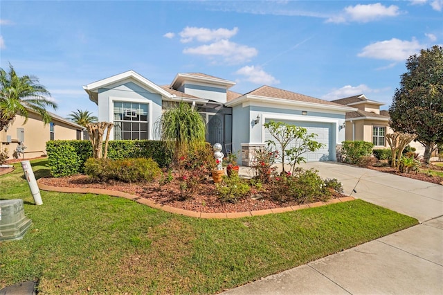 view of front facade with an attached garage, a front lawn, concrete driveway, and stucco siding