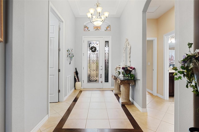 8780 Bridgeport Bay Cir, Mount Dora, FL 32757 - entryway featuring light tile patterned floors, a chandelier, arched walkways, and baseboards