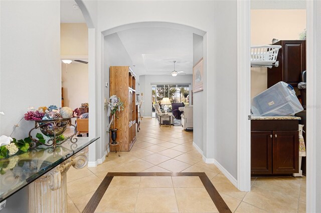 8780 Bridgeport Bay Cir, Mount Dora, FL 32757 - foyer featuring arched walkways, a ceiling fan, baseboards, and light tile patterned floors