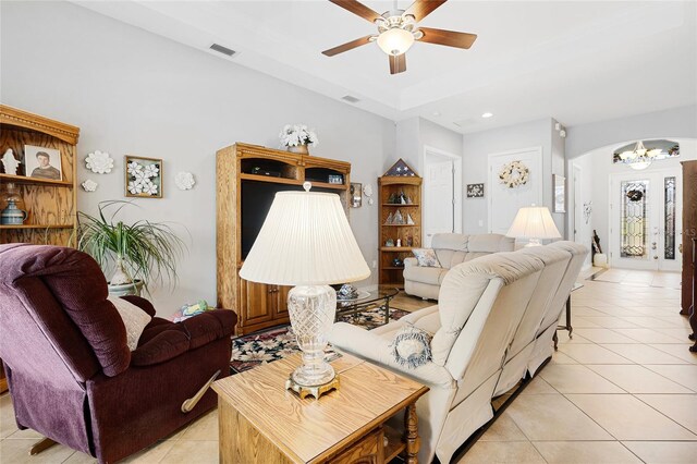 8780 Bridgeport Bay Cir, Mount Dora, FL 32757 - living room featuring arched walkways, a ceiling fan, light tile patterned floors, recessed lighting, and a chandelier