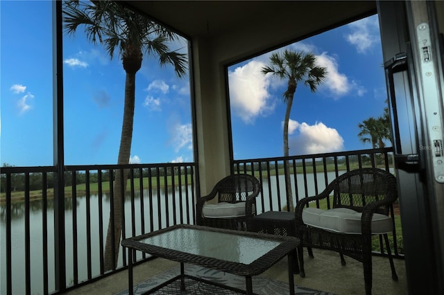 sunroom / solarium with a water view