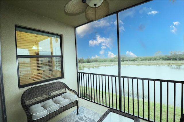 sunroom / solarium with a water view