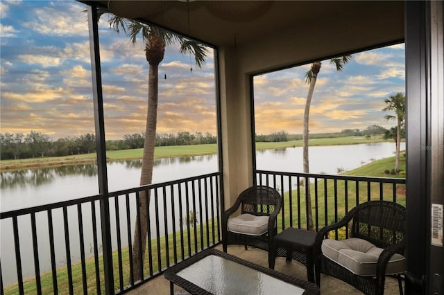 sunroom with a water view and a wealth of natural light