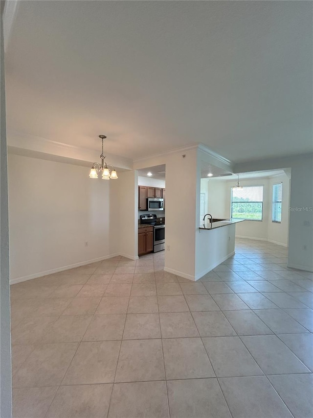 7005 River Hammock Dr Unit 207, Bradenton, FL 34212 - unfurnished living room featuring a chandelier, light tile patterned floors, and crown molding