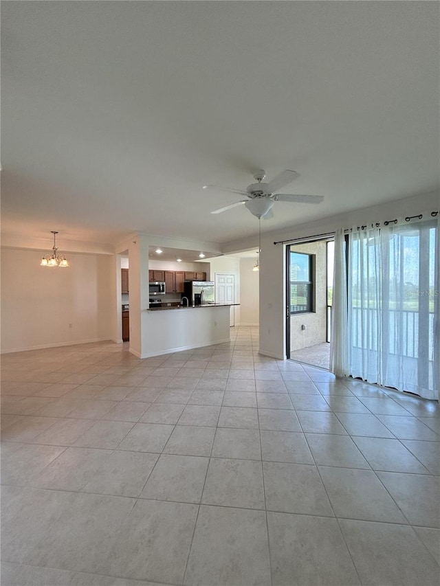 7005 River Hammock Dr Unit 207, Bradenton, FL 34212 - unfurnished living room featuring a chandelier, light tile patterned flooring, and a ceiling fan